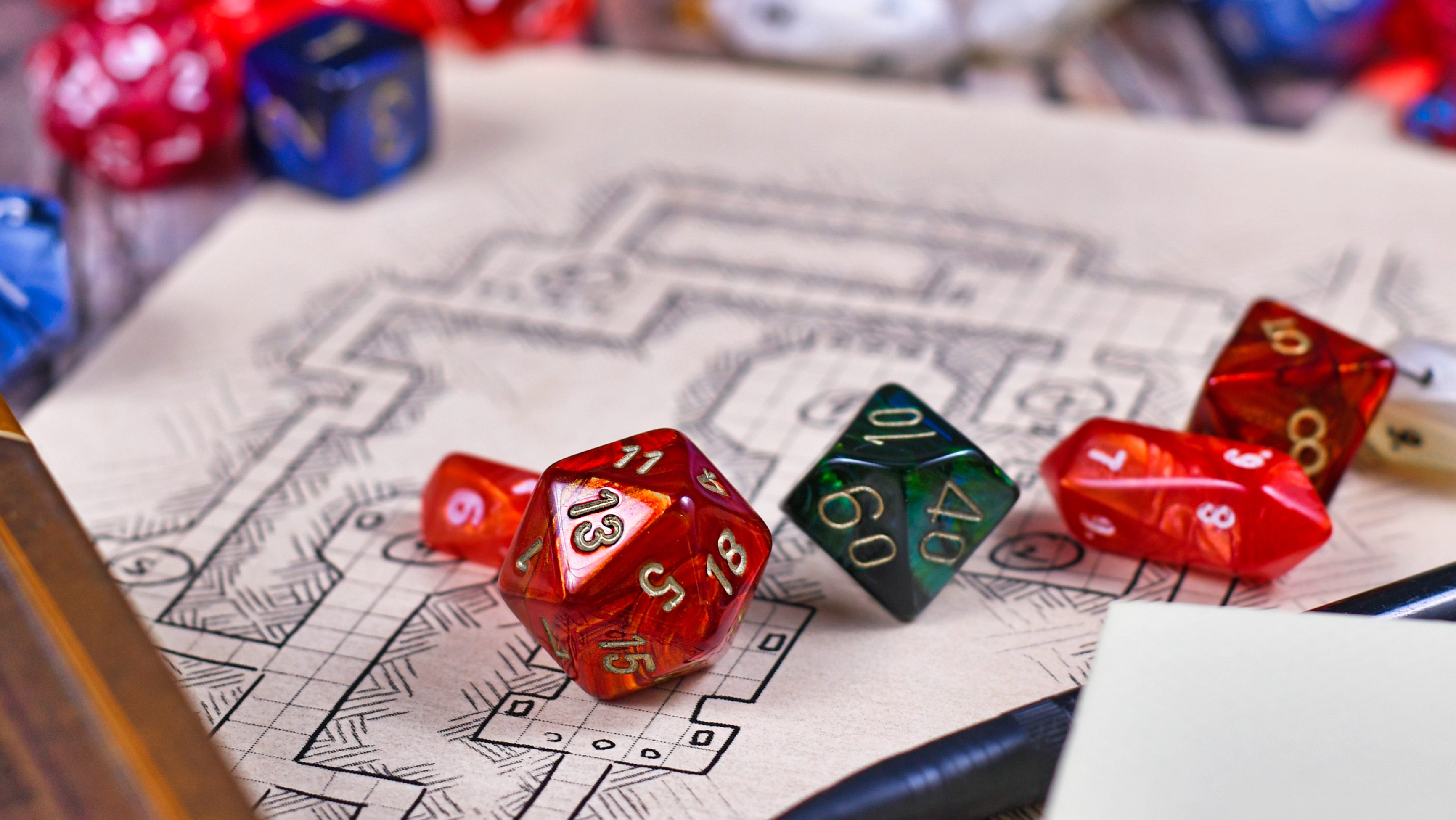 a mix of multi-sided dice on top of a dungeon map